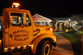 Historical exterior scene at Richland Manor with emergency vehicles